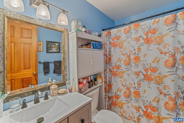 bathroom featuring vanity, toilet, and a shower with curtain