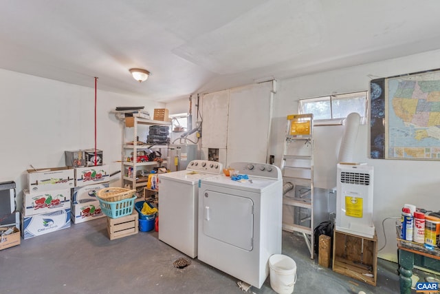 washroom with water heater and washing machine and dryer