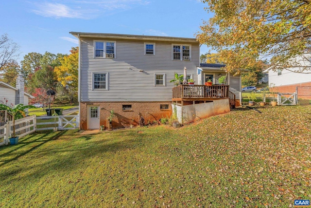 rear view of property featuring a wooden deck and a yard