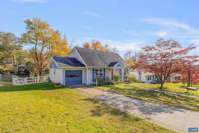 view of front of house featuring a front lawn and a garage