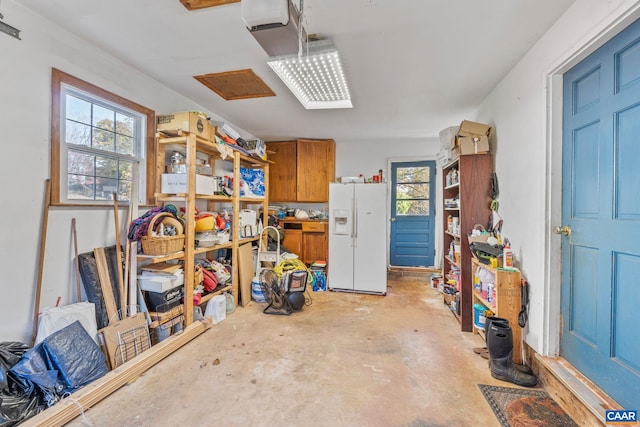 garage featuring white refrigerator with ice dispenser