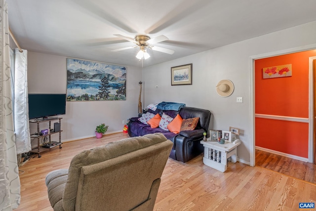 living room featuring light wood-type flooring and ceiling fan