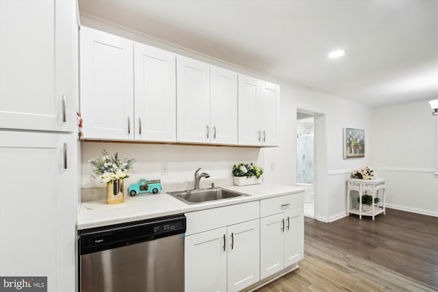 kitchen with dishwasher, white cabinets, sink, and hardwood / wood-style floors