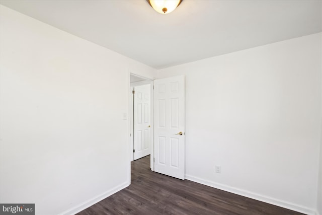 unfurnished room with dark hardwood / wood-style floors