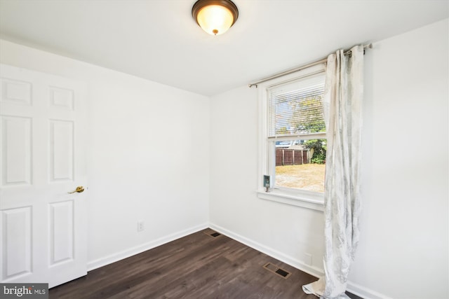 spare room with dark hardwood / wood-style flooring