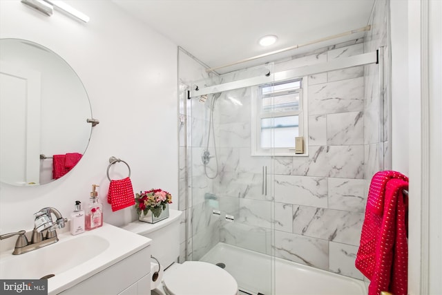 bathroom featuring toilet, walk in shower, and vanity