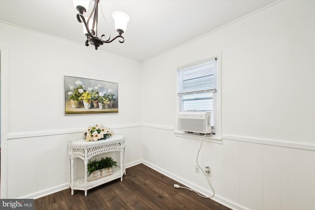 interior space with crown molding, cooling unit, a chandelier, and hardwood / wood-style floors