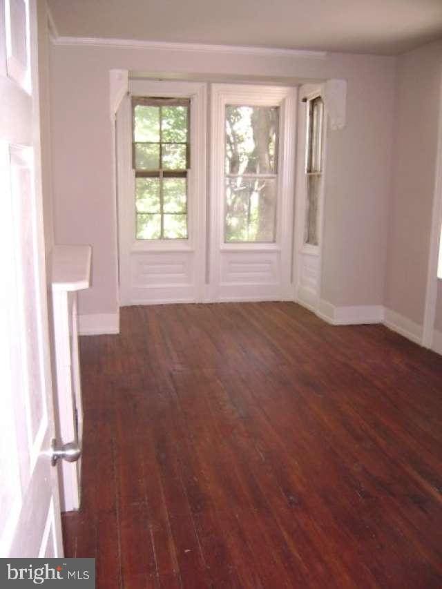 spare room featuring dark hardwood / wood-style floors