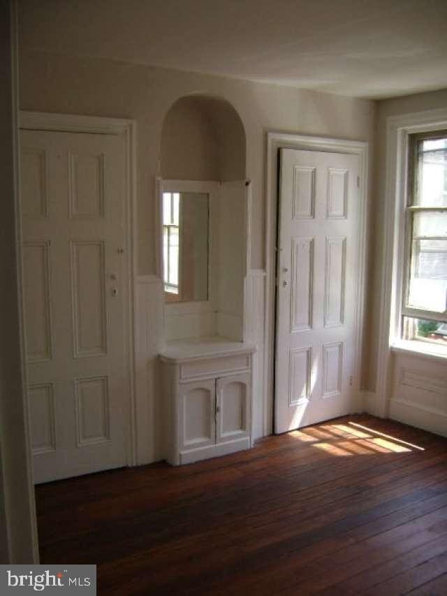 entryway with dark wood-type flooring and plenty of natural light