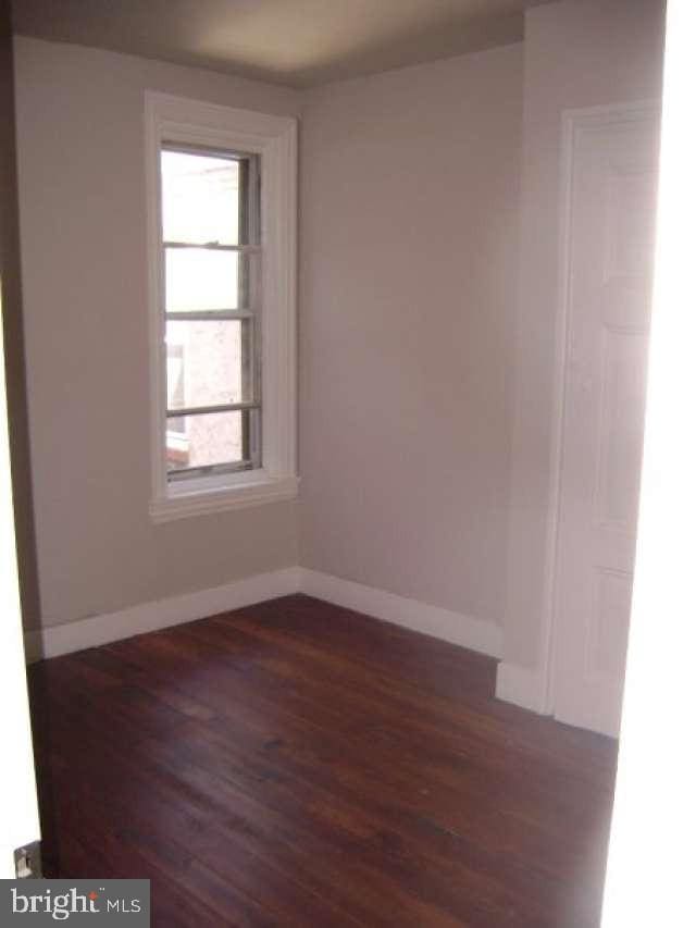 spare room featuring dark hardwood / wood-style floors