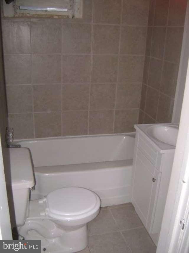 full bathroom with toilet, vanity, tile patterned floors, and shower / bathtub combination