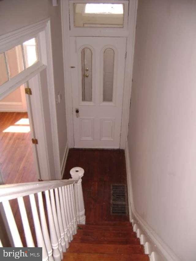 stairway featuring wood-type flooring