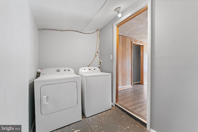 laundry area with washing machine and clothes dryer and dark wood-type flooring