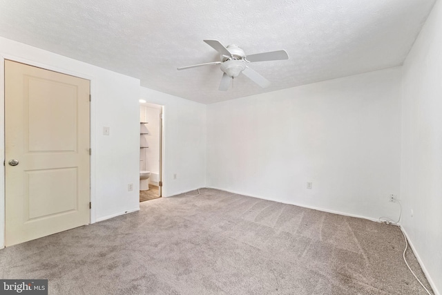 empty room featuring carpet, a textured ceiling, and ceiling fan