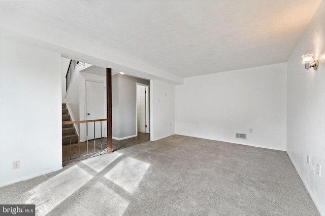 spare room with carpet floors and a textured ceiling