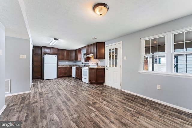 kitchen with dark hardwood / wood-style flooring, white appliances, a textured ceiling, and dark brown cabinets