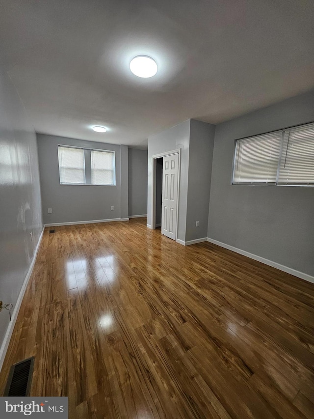 unfurnished room with hardwood / wood-style flooring