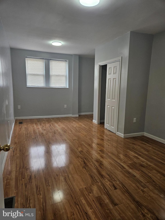 empty room with hardwood / wood-style floors