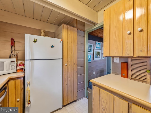 kitchen with white appliances, wooden ceiling, and wooden walls