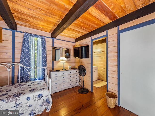 bedroom with hardwood / wood-style floors, wooden walls, beam ceiling, and wood ceiling