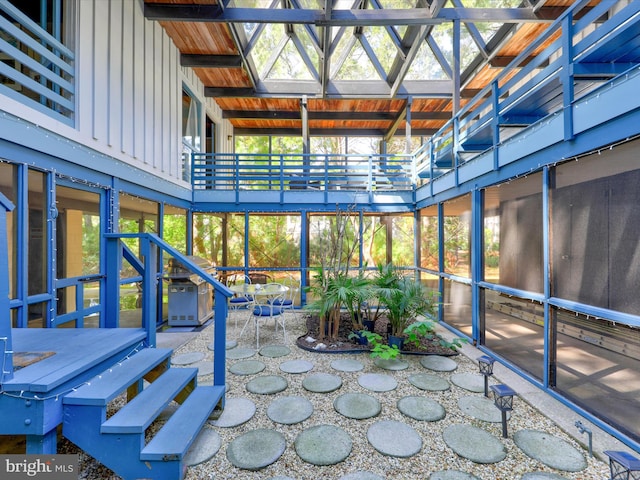 unfurnished sunroom with a skylight