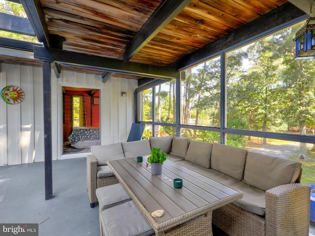 sunroom featuring wood ceiling and a healthy amount of sunlight