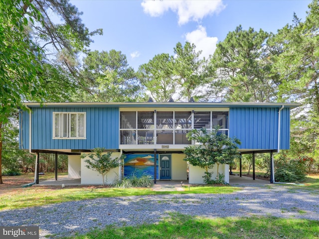 view of front of house featuring a sunroom and a carport