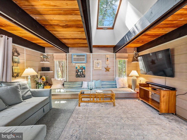 living room featuring beam ceiling and a skylight