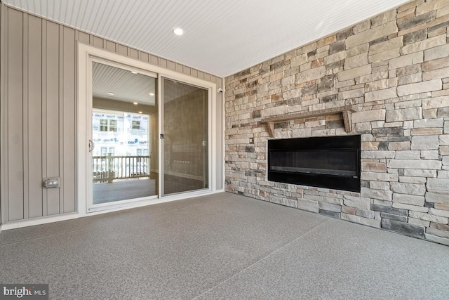 unfurnished living room featuring wood walls