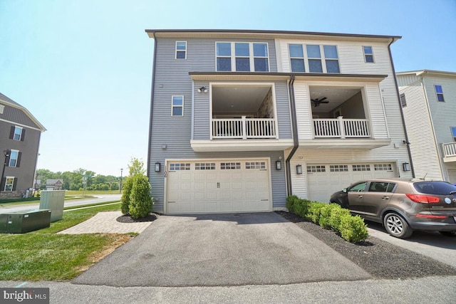 view of property with a garage and a balcony