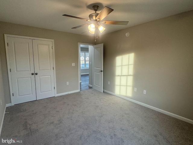 unfurnished bedroom with a closet, ceiling fan, and light colored carpet