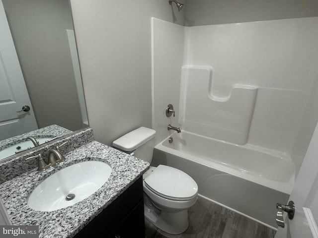 full bathroom with vanity, toilet, hardwood / wood-style flooring, and shower / bathing tub combination