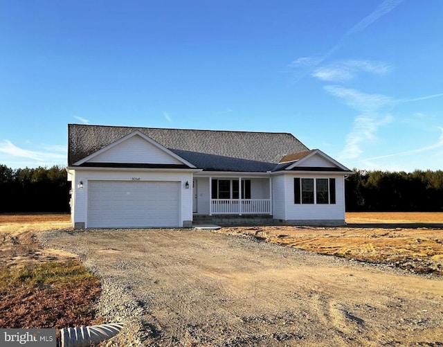 ranch-style home with a porch and a garage