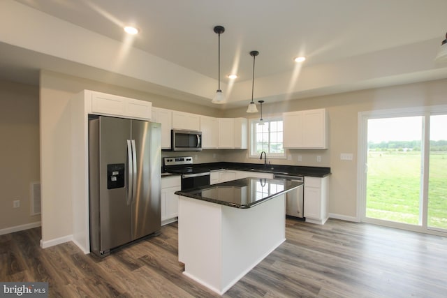 kitchen with sink, a center island, stainless steel appliances, and white cabinets