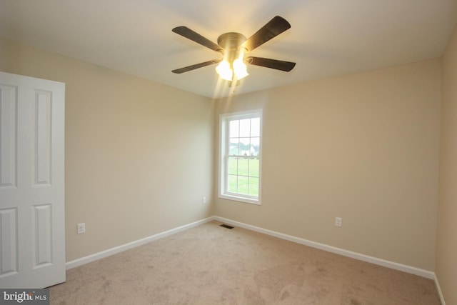 empty room featuring light carpet and ceiling fan