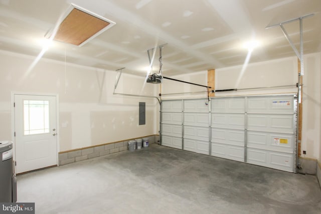 garage with a garage door opener and electric panel