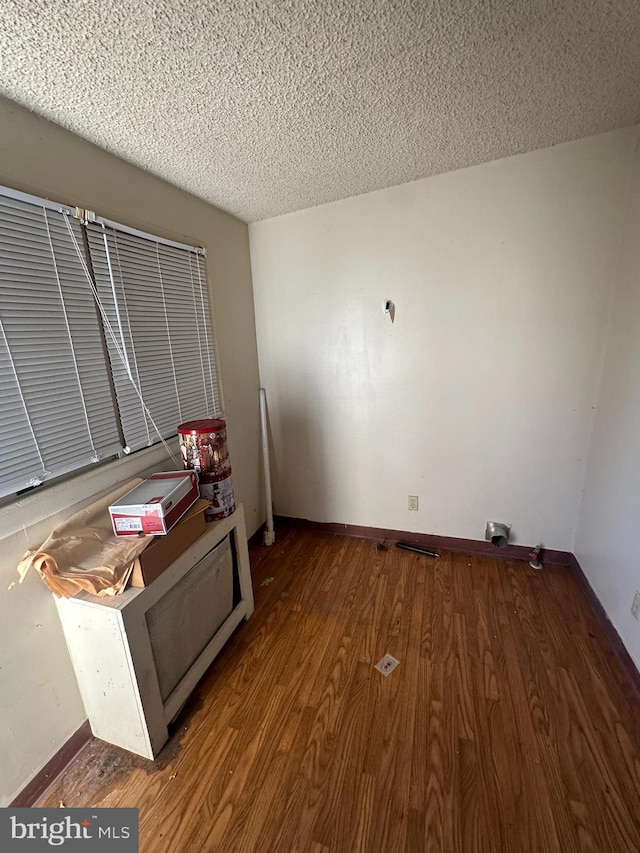 interior space featuring a textured ceiling and hardwood / wood-style flooring