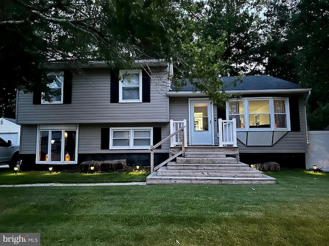 tri-level home with a front lawn