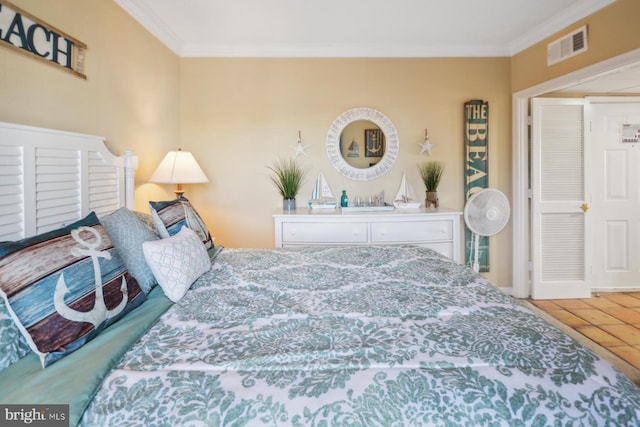 bedroom featuring ornamental molding and tile patterned flooring