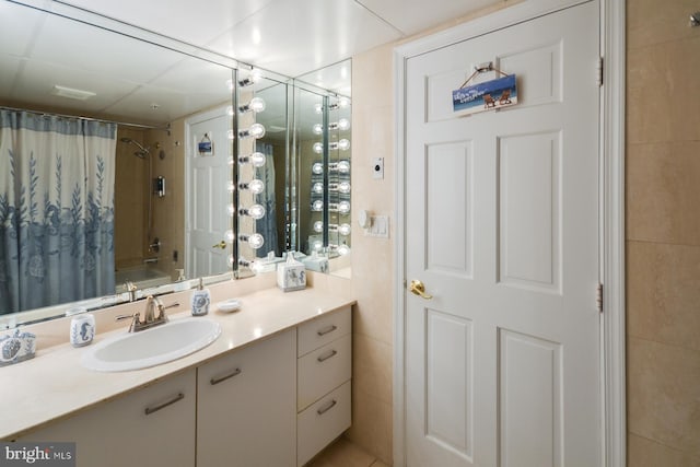 bathroom featuring vanity, shower / bath combo, and tile walls