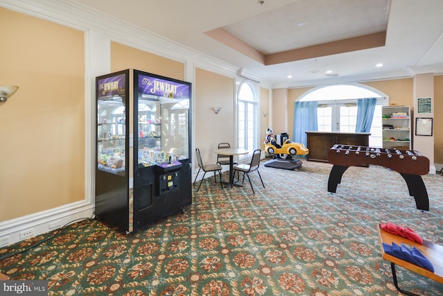 game room featuring carpet flooring, a raised ceiling, and ornamental molding