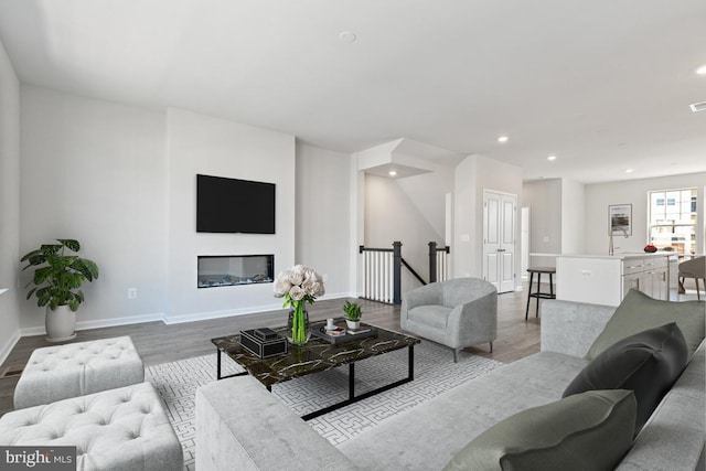 living room featuring sink and light wood-type flooring