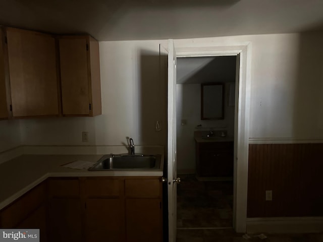 kitchen featuring sink and dark tile patterned flooring