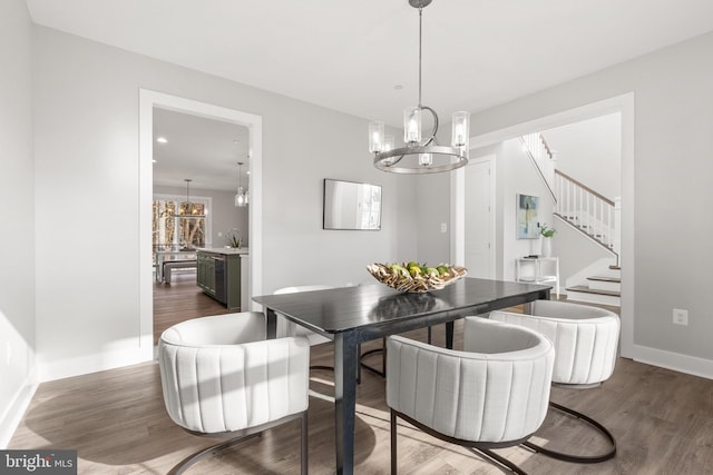 dining area with a notable chandelier and dark wood-type flooring