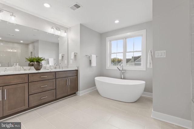 bathroom with tile patterned flooring, vanity, and independent shower and bath