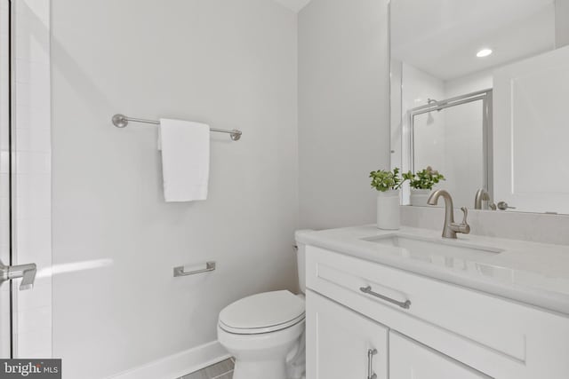 bathroom with tile patterned floors, vanity, an enclosed shower, and toilet