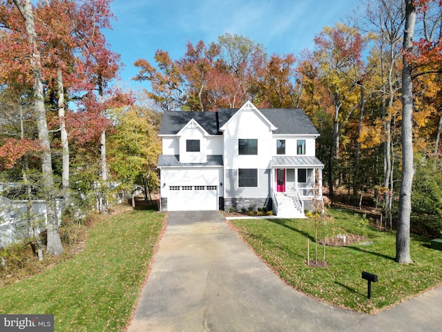 view of front of home with a front lawn and a garage