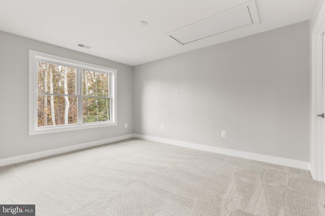 unfurnished room featuring light carpet