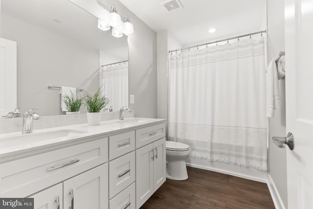 full bathroom featuring shower / bath combination with curtain, vanity, wood-type flooring, and toilet