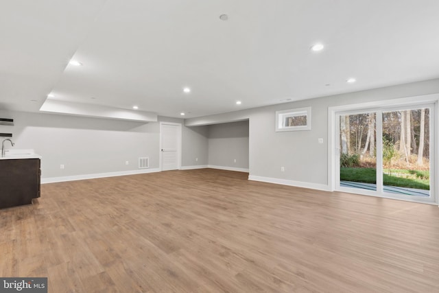 basement featuring light wood-type flooring